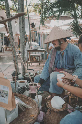 Choo Jai handing over a freshly brewed coffee in a decorated cup.
