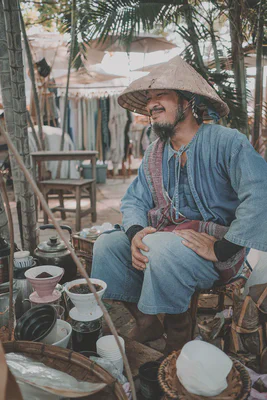 Portrait of Choo Jai, smiling gently with his eyes closed.